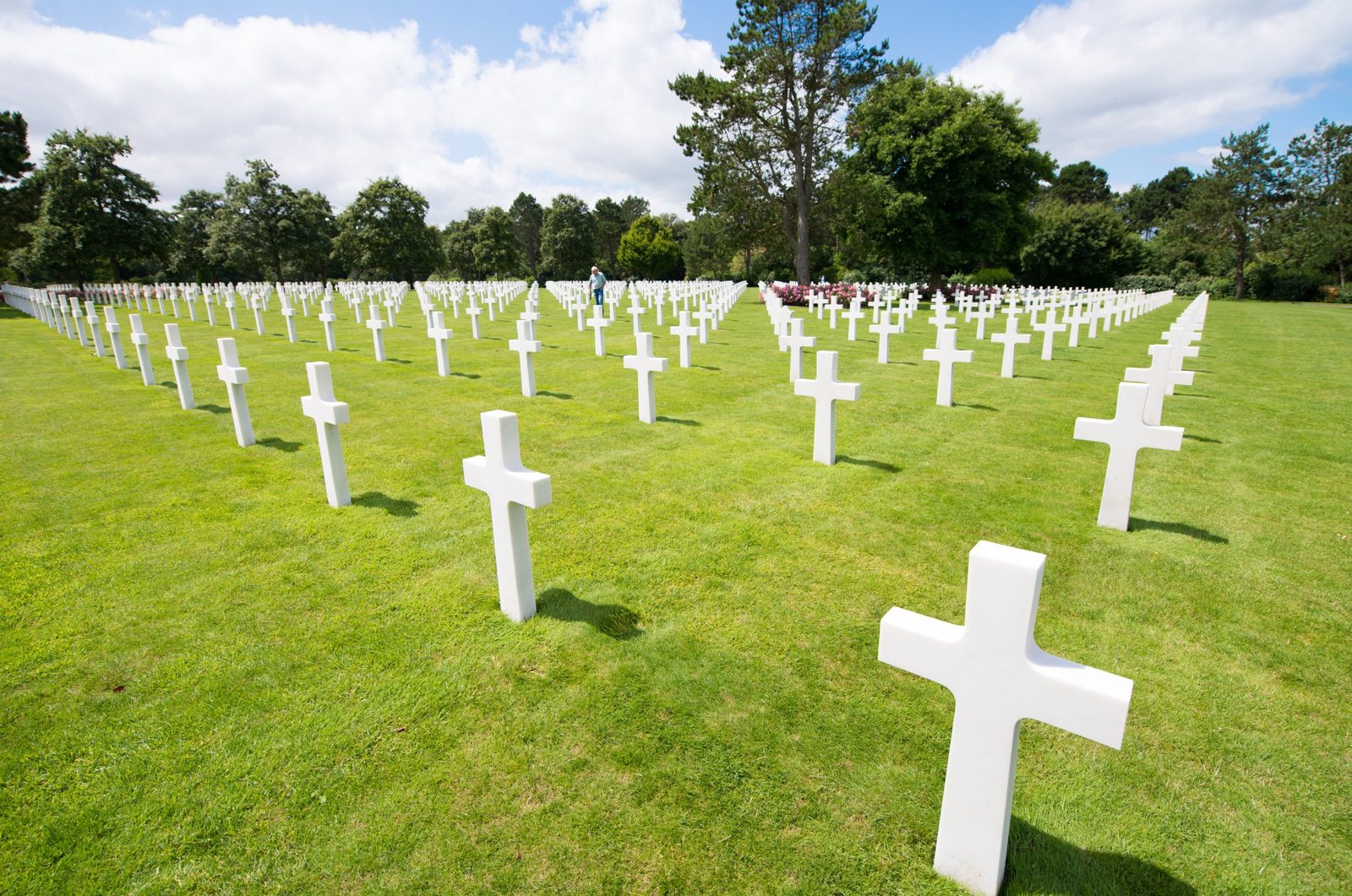Rows of white marble crosses on green grass at the Normandy American Cemetery