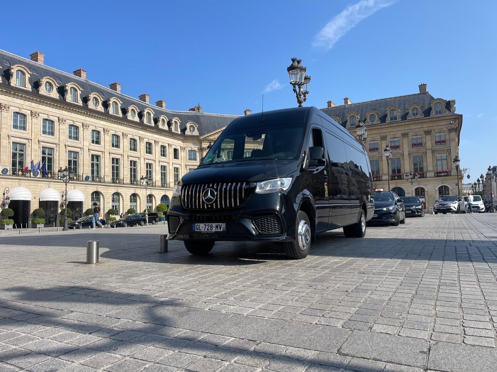 Black Mercedes Sprinter van parked on Place Vendôme in Paris
