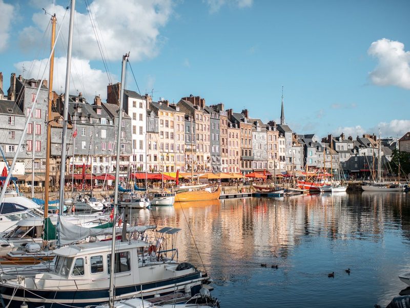 Boats and tall houses around the old harbor of Honfleur