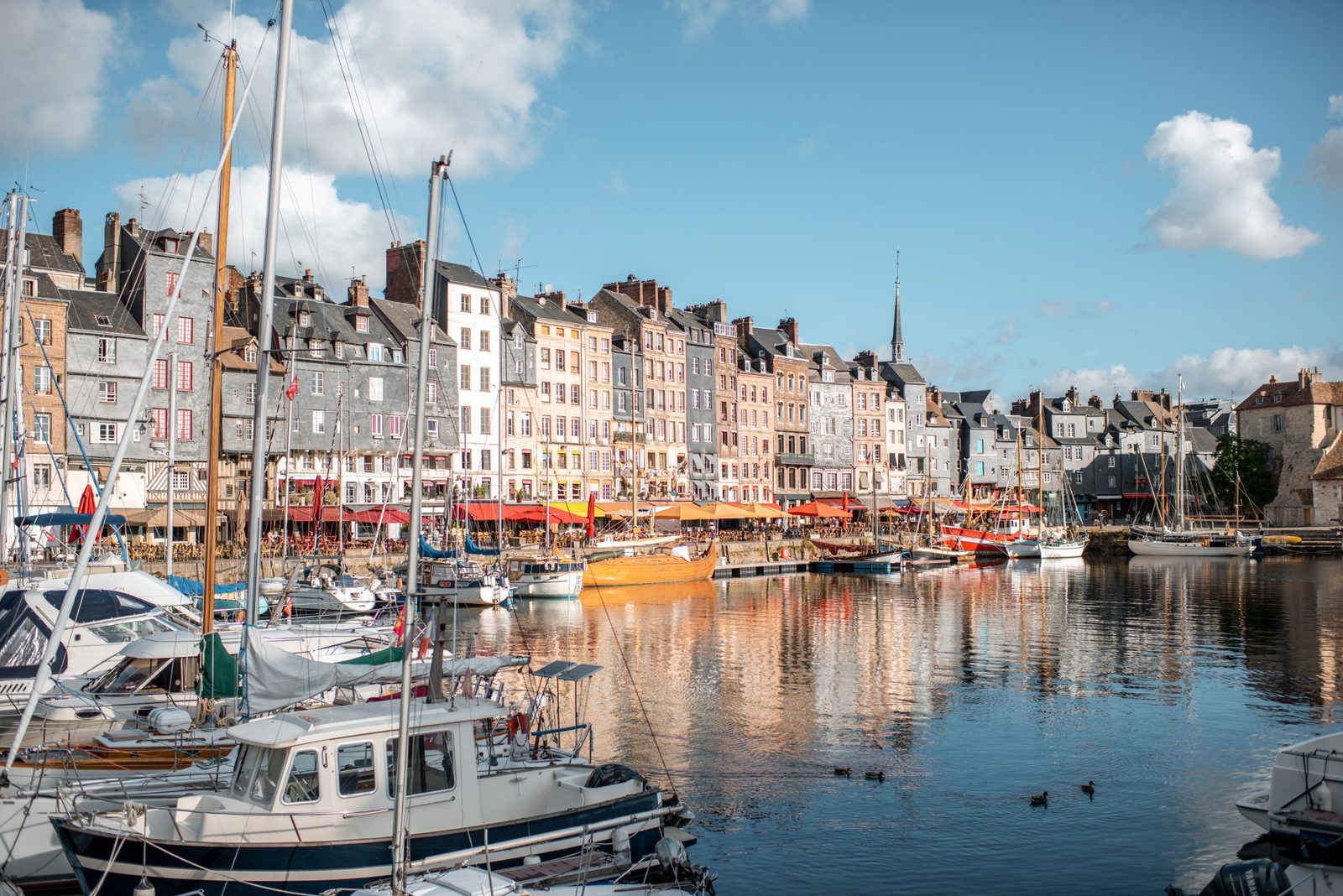 Boats and tall houses around the old harbor of Honfleur