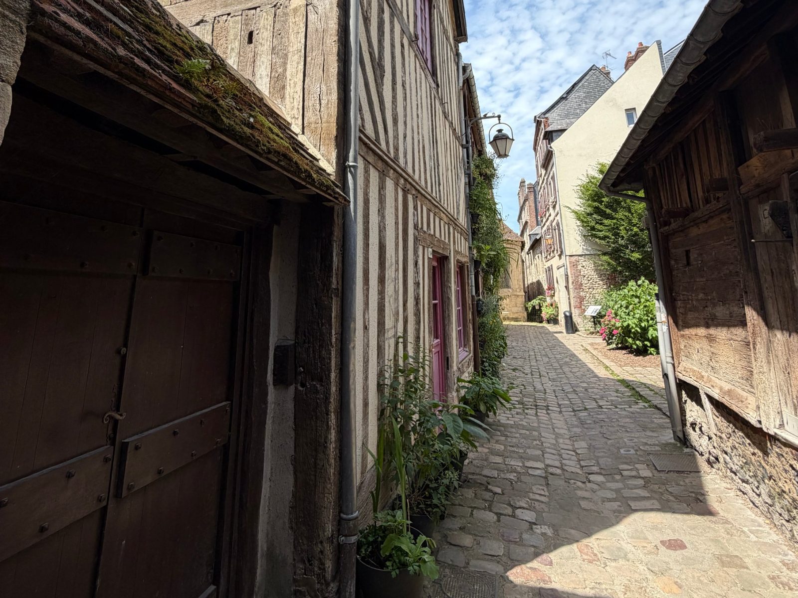 A cobbled lane lined with old half-timbered houses in Honfleur