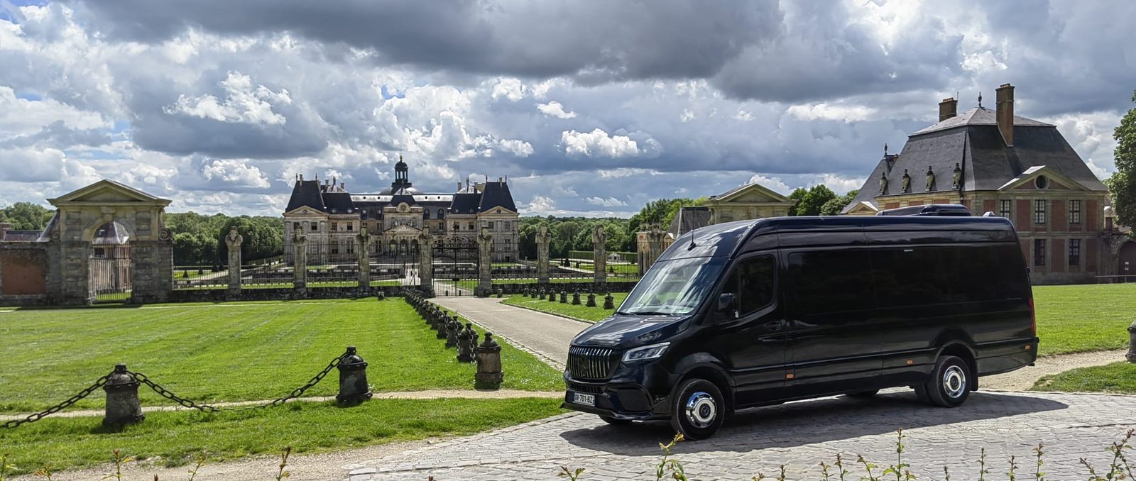 Black Mercedes Sprinter van parked on the cobbles in front of the gates of Vaux-le-Vicomte